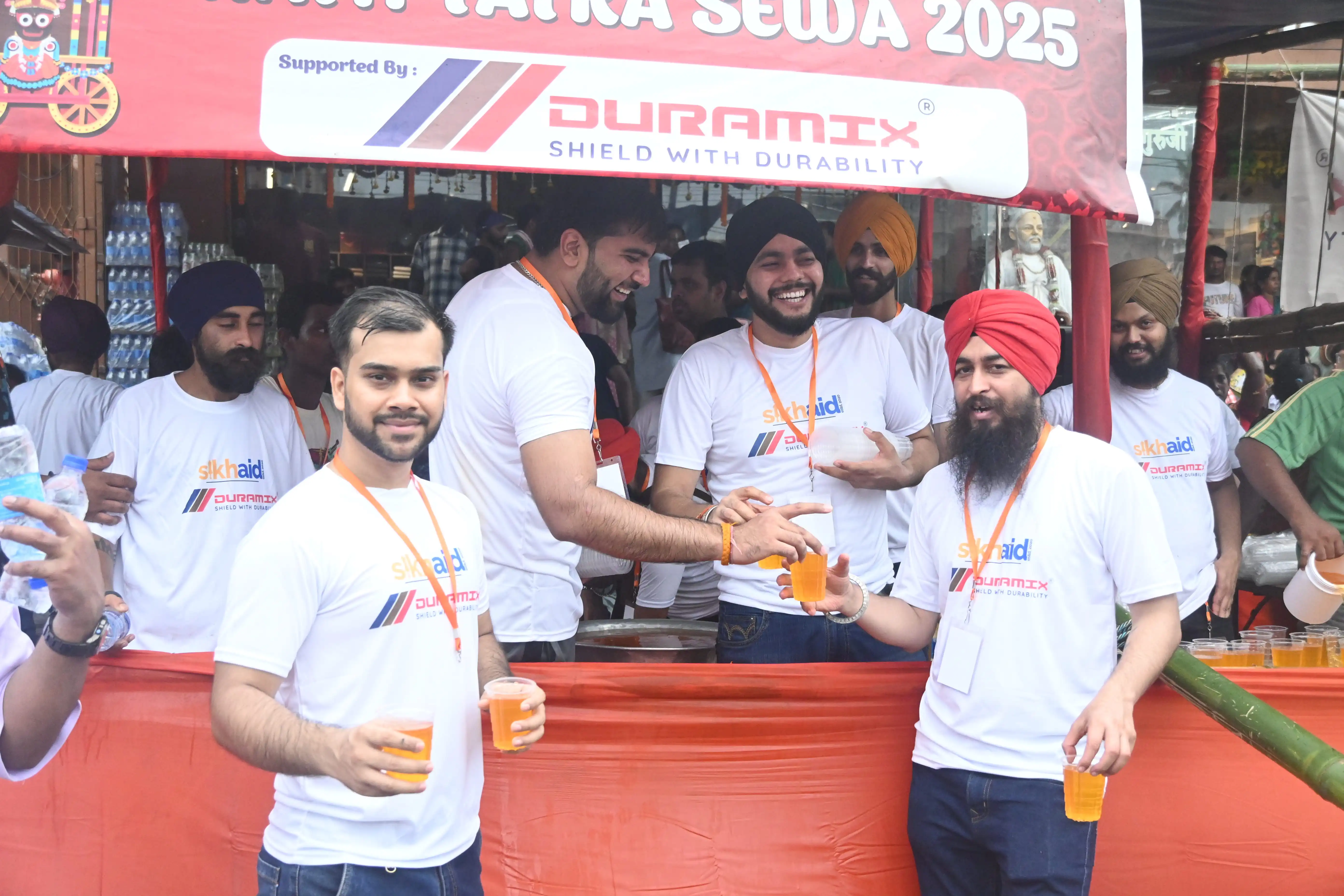 Devotees receiving refreshments at a Sikh Aid seva station during the 2025 Ratha Yatra