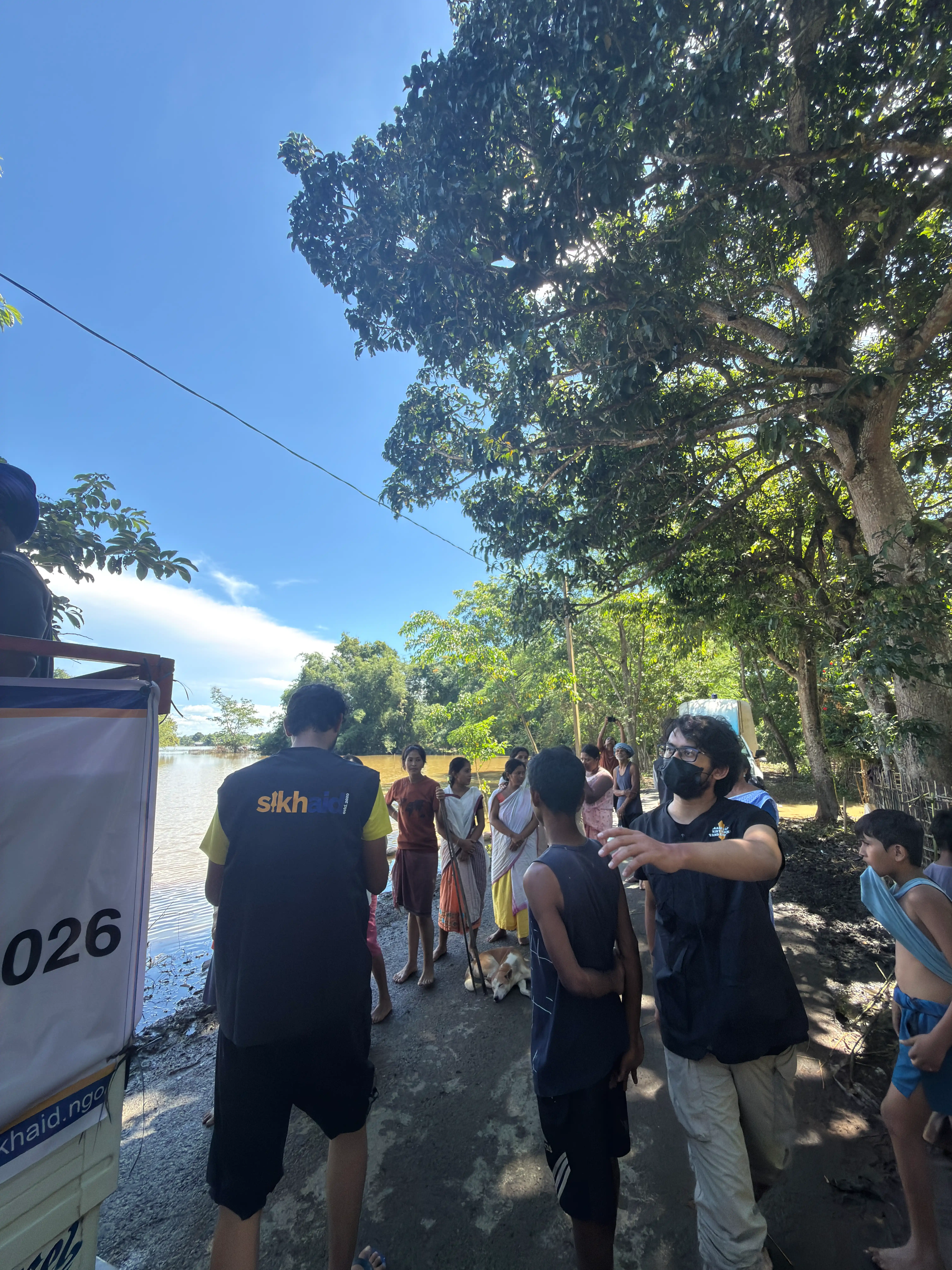 Volunteers distributing relief supplies during the Assam floods